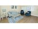 Comfortable living area with wood floors, neutral furniture, a large window, and stylish decor at 22375 Edgewater Dr # 128, Port Charlotte, FL 33980