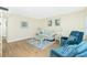Inviting living room featuring wood floors, neutral furniture, stylish decor, and comfortable seating at 22375 Edgewater Dr # 128, Port Charlotte, FL 33980