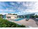 Community pool area with lounge chairs, umbrellas, and well-maintained landscaping at 22375 Edgewater Dr # 128, Port Charlotte, FL 33980