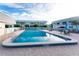 Inviting community pool surrounded by lounge chairs and lush landscaping in a desirable neighborhood at 22375 Edgewater Dr # 128, Port Charlotte, FL 33980