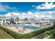 Community pool with lounge chairs surrounded by landscaped grounds in a residential neighborhood at 22375 Edgewater Dr # 128, Port Charlotte, FL 33980