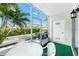 Screened in porch with table and chairs and views of the neighborhood at 22375 Edgewater Dr # 128, Port Charlotte, FL 33980
