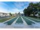 Community shuffleboard court with benches, palm trees, and well-kept grounds at 22375 Edgewater Dr # 128, Port Charlotte, FL 33980