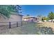 Fenced backyard featuring a screened patio with lush green grass and mature trees at 23344 Van Buren Ave, Punta Gorda, FL 33980