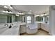 Luxurious bathroom featuring dual vanities with marble countertops, soaking tub, and elegant fixtures at 23344 Van Buren Ave, Punta Gorda, FL 33980
