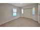 Cozy bedroom with neutral carpet, and lots of natural light from 3 windows at 23344 Van Buren Ave, Punta Gorda, FL 33980