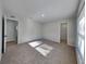 Bright bedroom with neutral carpet, and access to closets, and attached bathroom at 23344 Van Buren Ave, Punta Gorda, FL 33980