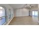 Bright living room features ceiling fan, wood-look floors, and lots of natural light from large windows at 23344 Van Buren Ave, Punta Gorda, FL 33980