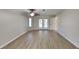 Spacious living room features ceiling fan, wood-look floors, and access to the outdoors through glass doors at 23344 Van Buren Ave, Punta Gorda, FL 33980