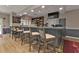 Well-equipped bar with counter seating, liquor display, and wood-look flooring for a stylish social space at 24317 Kintail Ct, Punta Gorda, FL 33980