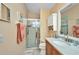 Bathroom featuring a single sink with wood cabinets and a glass-enclosed shower at 24317 Kintail Ct, Punta Gorda, FL 33980
