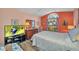 Bedroom boasting a stained glass window, wood floors, and a television at 24317 Kintail Ct, Punta Gorda, FL 33980