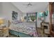 Bedroom with light-colored walls, hardwood floors, and a TV mounted on the wall at 24317 Kintail Ct, Punta Gorda, FL 33980