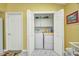 Laundry room featuring white washer and dryer, storage cabinets, and adjacent to a doorway at 24317 Kintail Ct, Punta Gorda, FL 33980