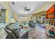 Bright living room featuring vaulted ceilings, ceiling fan and sliding glass doors to a screened lanai at 24317 Kintail Ct, Punta Gorda, FL 33980