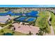 Aerial view showcasing community tennis courts, golf cart parking, and beautiful landscaping at 24317 Kintail Ct, Punta Gorda, FL 33980