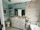 Well-lit bathroom with a white single sink vanity, framed mirror, and neutral stone-look tile at 25188 Marion Ave # 1004, Punta Gorda, FL 33950