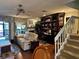 Inviting living room with hardwood floors, ceiling fan, and large built-in bookcase at 25188 Marion Ave # 1004, Punta Gorda, FL 33950