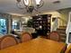 Inviting living room with hardwood floors, ceiling fan, and large built-in bookcase at 25188 Marion Ave # 1004, Punta Gorda, FL 33950