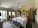 Bright main bedroom with serene view, ceiling fan, and an ensuite bath at 25188 Marion Ave # 1004, Punta Gorda, FL 33950