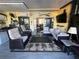 Enclosed outdoor living area with woven furniture, TV, and sliding doors to indoor space at 25188 Marion Ave # 1004, Punta Gorda, FL 33950