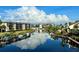 Beautiful waterfront homes reflecting clouds with private docks on a sunny day at 25188 Marion Ave # 1004, Punta Gorda, FL 33950
