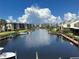 Scenic view of a waterfront community featuring boat docks and lush landscaping under a bright sky at 25188 Marion Ave # 1004, Punta Gorda, FL 33950
