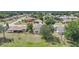 Aerial view of a beige two-story home featuring a spacious backyard and mature trees at 26100 Paysandu Dr, Punta Gorda, FL 33983