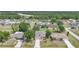 Aerial view of a charming two-story home with a well maintained lawn and trees in a lush residential neighborhood at 26100 Paysandu Dr, Punta Gorda, FL 33983