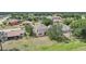 Aerial view of a beige two-story home featuring a spacious backyard and mature trees at 26100 Paysandu Dr, Punta Gorda, FL 33983