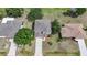 An aerial front view of a two-story house with mature trees and a long driveway at 26100 Paysandu Dr, Punta Gorda, FL 33983