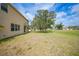 Expansive backyard with lush greenery and mature trees, perfect for outdoor activities at 26100 Paysandu Dr, Punta Gorda, FL 33983