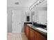 Bathroom features a double sink vanity with black countertops at 26100 Paysandu Dr, Punta Gorda, FL 33983