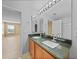 Bathroom features a double sink vanity with modern faucets and granite counters at 26100 Paysandu Dr, Punta Gorda, FL 33983