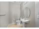 Powder room with a pedestal sink, toilet, and tiled floors at 26100 Paysandu Dr, Punta Gorda, FL 33983