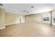 Spacious bedroom with wood-look flooring, ceiling fan, and natural light at 26100 Paysandu Dr, Punta Gorda, FL 33983