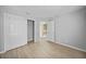 A bright bedroom featuring wood-look flooring and ample closet space at 26100 Paysandu Dr, Punta Gorda, FL 33983