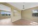Bright dining room featuring wood floors, neutral walls, window and chandelier at 26100 Paysandu Dr, Punta Gorda, FL 33983