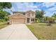 Charming two-story home featuring an attached two-car garage and a well-kept lawn at 26100 Paysandu Dr, Punta Gorda, FL 33983