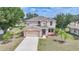 Aerial view of a charming two-story home with a two-car garage and lush lawn at 26100 Paysandu Dr, Punta Gorda, FL 33983
