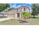 Charming two-story home with a two car garage, screened in porch, and well maintained landscaping at 26100 Paysandu Dr, Punta Gorda, FL 33983