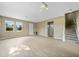 Spacious living room featuring wood floors, ample light, and staircase at 26100 Paysandu Dr, Punta Gorda, FL 33983