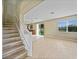 Open-concept living room with wood floors, stairs, natural light, and sliding glass doors at 26100 Paysandu Dr, Punta Gorda, FL 33983