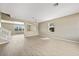 Open-concept living room featuring stairs, wood floors, and natural light at 26100 Paysandu Dr, Punta Gorda, FL 33983