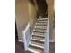 Modern staircase with wooden steps, white banister, and built-in accent lighting at 26100 Paysandu Dr, Punta Gorda, FL 33983