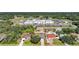 Aerial view of the property in a residential neighborhood with a school, lake and surrounded by forest at 2751 S Cranberry Blvd, North Port, FL 34286