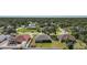 Aerial view of a neighborhood with tree lined streets and homes with various roof types and colors at 2751 S Cranberry Blvd, North Port, FL 34286