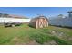 Backyard shed sits on a grassy lawn next to a trailer with a white fence on the property line at 2751 S Cranberry Blvd, North Port, FL 34286