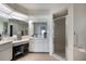 Well-lit bathroom featuring a glass-enclosed shower and a vanity with a large mirror at 2751 S Cranberry Blvd, North Port, FL 34286