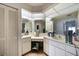 Bright bathroom with a tile floor, white cabinets, and a vanity with a large mirror at 2751 S Cranberry Blvd, North Port, FL 34286